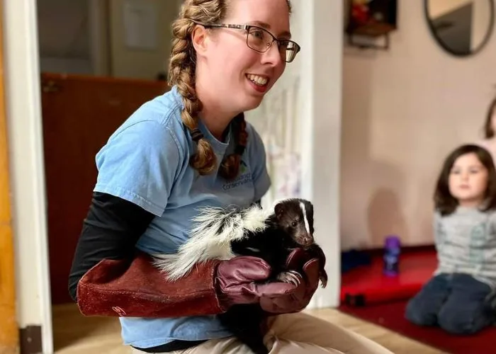 educator with skunk
